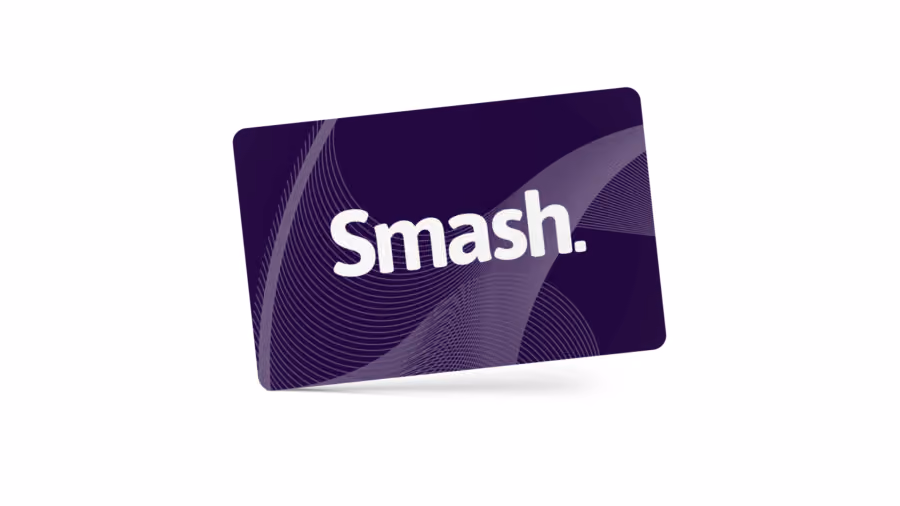 Cartão presente roxo-escuro inclinado sobre fundo branco, com a marca Smash em branco e linhas curvas ao fundo